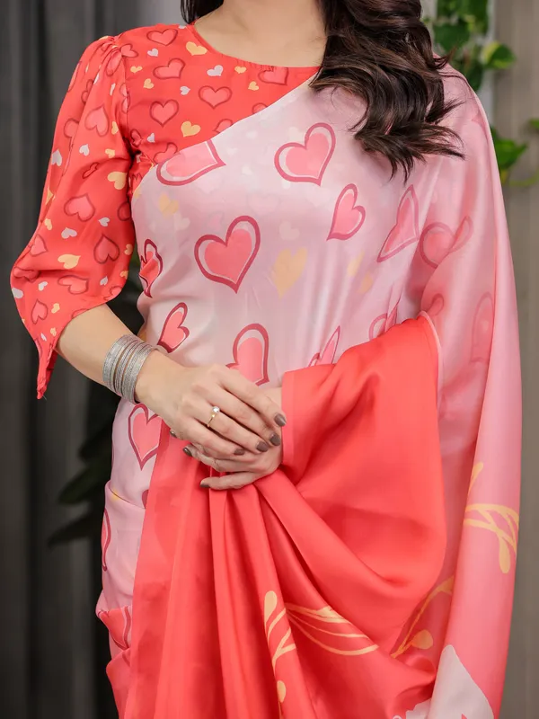 Coral_Red_&_Blush_Pink_Heart_Printed_Satin_Georgette_Saree_with_Romantic_Couple_Pallu_and_Attached_Heart_Print_Blouse_–_5.5_Meter_Designer_Saree_for_Valentine’s_Day_&_Anniversary_Wear