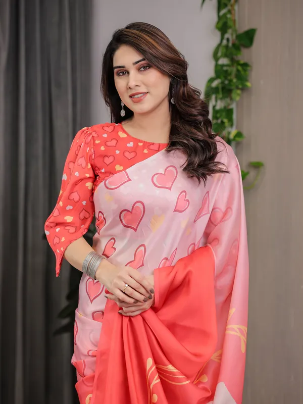 Coral_Red_&_Blush_Pink_Heart_Printed_Satin_Georgette_Saree_with_Romantic_Couple_Pallu_and_Attached_Heart_Print_Blouse_–_5.5_Meter_Designer_Saree_for_Valentine’s_Day_&_Anniversary_Wear