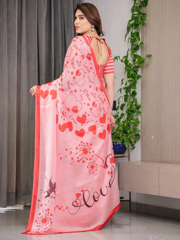 Blush_Pink_&_Coral_Red_Heart_Print_Satin_Georgette_Saree_with_Romantic_Love_Typography_Pallu_and_Attached_Striped_Blouse_–_5.5_Meter_Designer_Saree_for_Valentine’s_Day_&_Anniversary_Wear