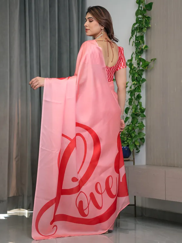 Blush_Pink_Satin_Georgette_Saree_with_Bold_Red_Heart_&_Love_Typography_Pallu_and_Attached_Coral_Red_Geometric_Blouse_–_5.5_Meter_Romantic_Designer_Saree_for_Valentine’s_Day_&_Anniversary_Wear