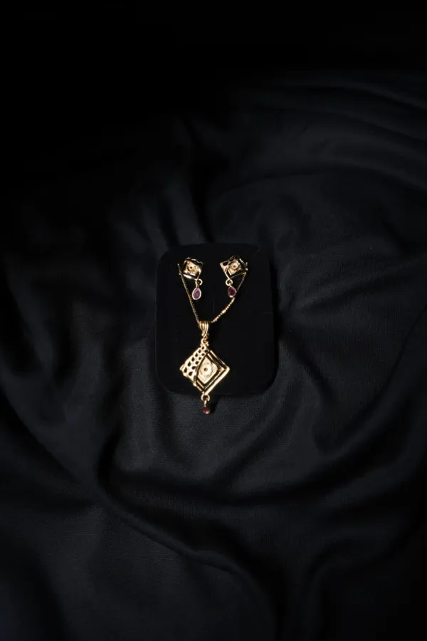 Gold_Toned_Pendant_Set_With_Maroon_Stones_For_Women