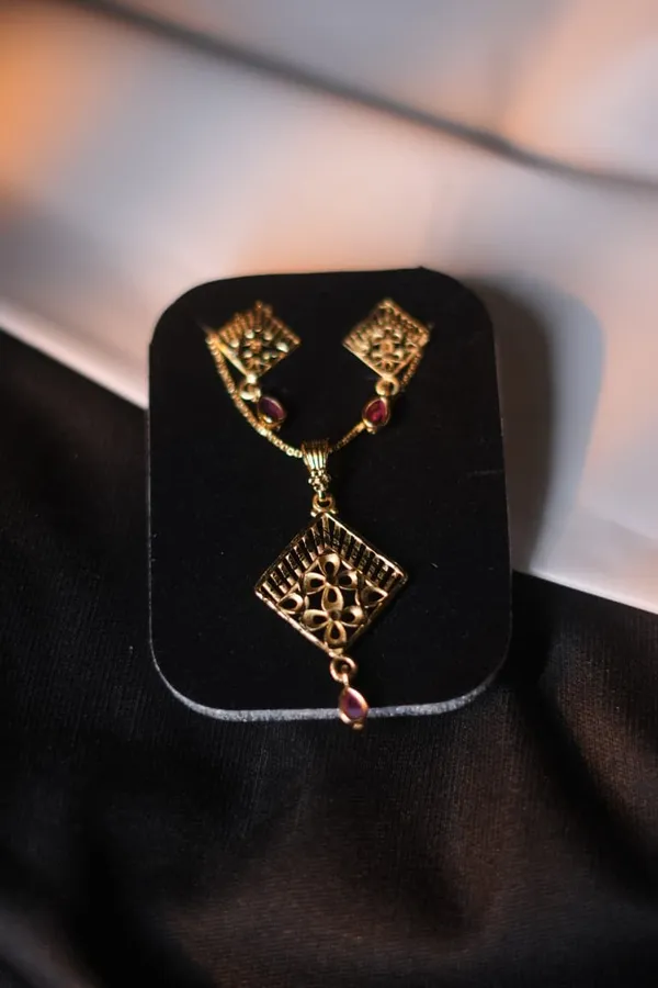 Gold_Tone_Floral_Cutwork_Pendant_Set_With_Red_Stone_Accents