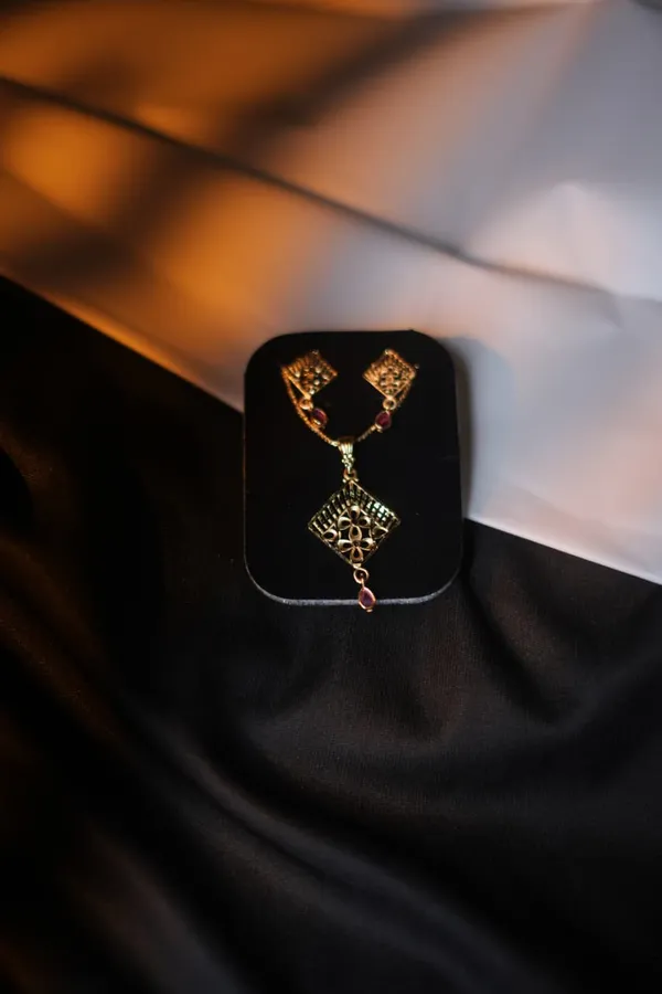 Gold_Tone_Floral_Cutwork_Pendant_Set_With_Red_Stone_Accents