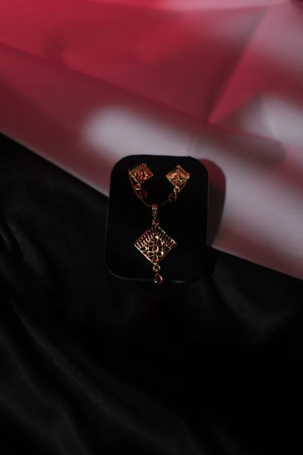 Gold_Tone_Floral_Cutwork_Pendant_Set_With_Red_Stone_Accents