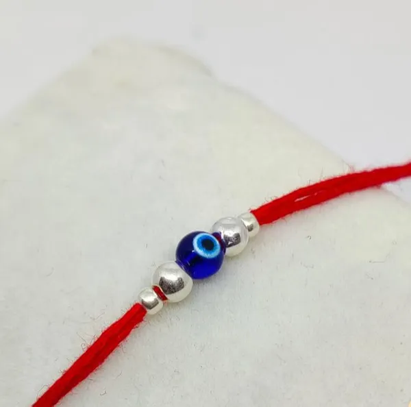 Silvering_Nazar_Suraksha_Bead_Thread_Rakhi_(design_2)