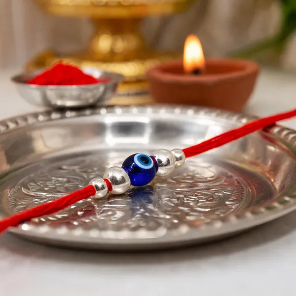 Silvering_Nazar_Suraksha_Bead_Thread_Rakhi_(design_2)