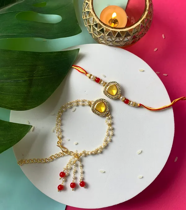 Elegant_Bhaiya_Bhabhi_Lumba_&_Pearl_Rakhi_With_Roli_Chawal_&_Card