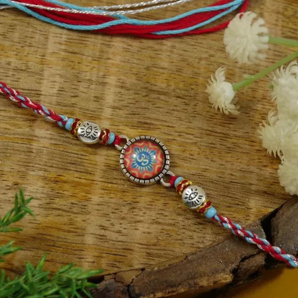 Enamel_Silver_Om_Rakhi_for_Bhai_-_Elegant_Design_with_Multicolour_Thread