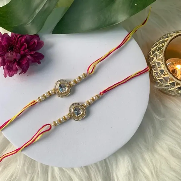 Dazzling_Pearl_Kundan_Stone_Rakhi_with_Roli_Chawal_&_Card_(Pack_of_2)
