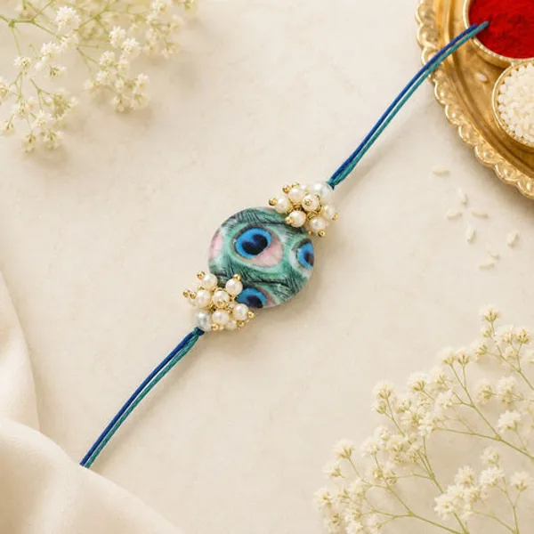 Beautiful_Peacock_Feather_Rakhi_with_Roli_Chawal_&_Card