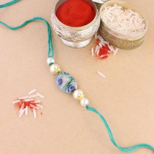 Beautiful_Peacock_Feather_Rakhi_with_Roli_Chawal_&_Card