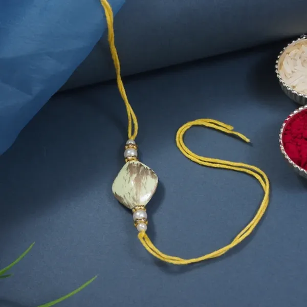 Delicate_Pearl_Beads_Yellow_Rakhi_with_Roli_Chawal_&_Rakshabandhan_Card
