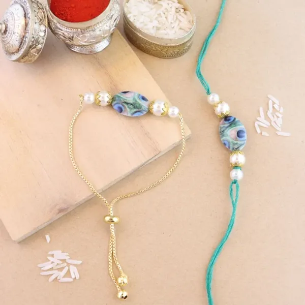 Elegant_Bhaiya_Bhabhi_Lumba_Peacock_Feather_Rakhi_With_Roli_Chawal_&_Card
