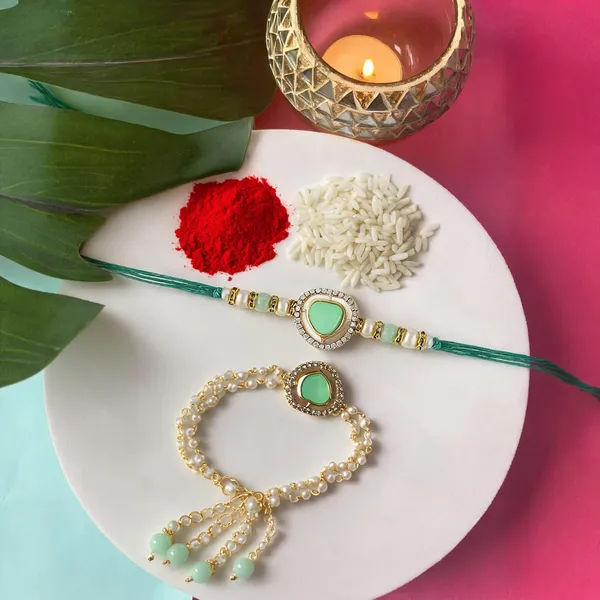Elegant_Bhaiya_Bhabhi_Lumba_&_Pearl_Rakhi_With_Roli_Chawal_&_Card