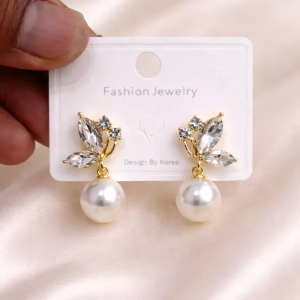 Floral/leaf-inspired_arrangement_with_three_clear,_faceted_crystal_stones_on_each_earring