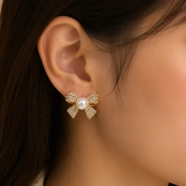Korean-inspired_sparkling_crystal_bow_stud_earrings_with_a_lustrous_pearl_center_and_elegant_gold-tone