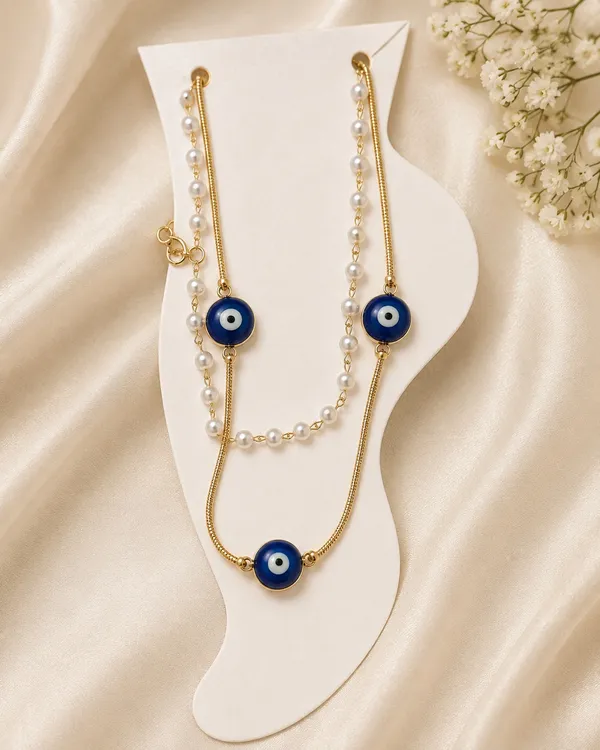 NAZARAA_Anklet_is_an_elegant_layered_anklet_designed_with_a_beautiful_combination_of_gold-tone_chains,_lustrous_white_pearls,_and_deep-blue_evil-eye_charms.