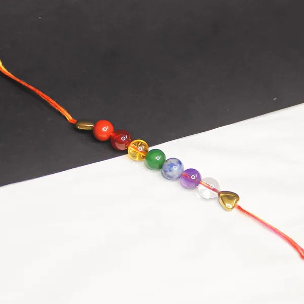 Seven_Chakra_Crystal_Rakhi_With_Golden_Hematite_Charm_For_Balance,_Protection,_&_Energy_Healing