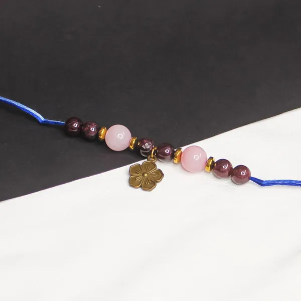 Relationship_Crystal_Rakhi_With_Hanging_Flower_Charm_Rose_Quartz_&_Red_Garnet_Crystal_Embrace_The_Bond_Of_Love_This_Raksha_Bandhan