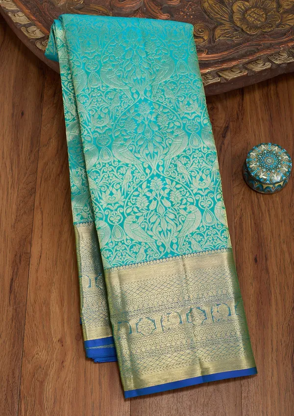 Turquoise_Blue_Silk_Jaal_Saree_With_Matching_Blouse_Piece