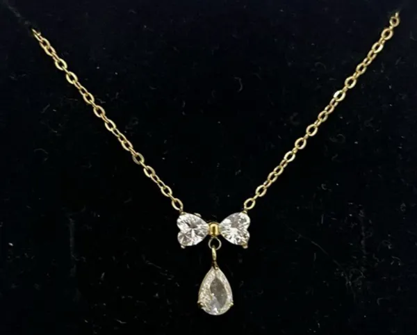 ELISH_–_Gold-Tone_Stainless_Steel_CZ_Bow_Pendant_Necklace