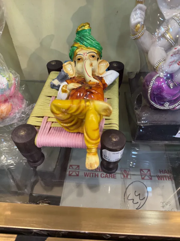 Reclining_Ganesha_Idol_On_Woven_Charpai