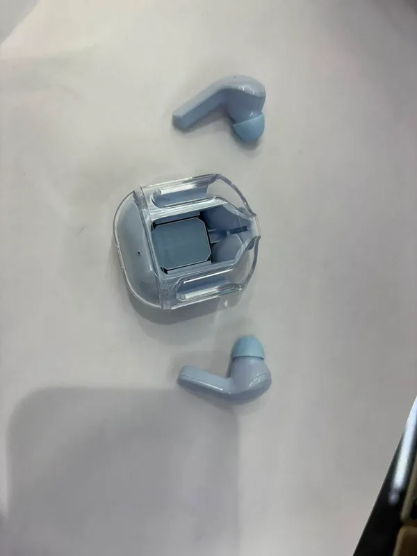Blue_Wireless_Earbuds_With_Transparent_Charging_Case