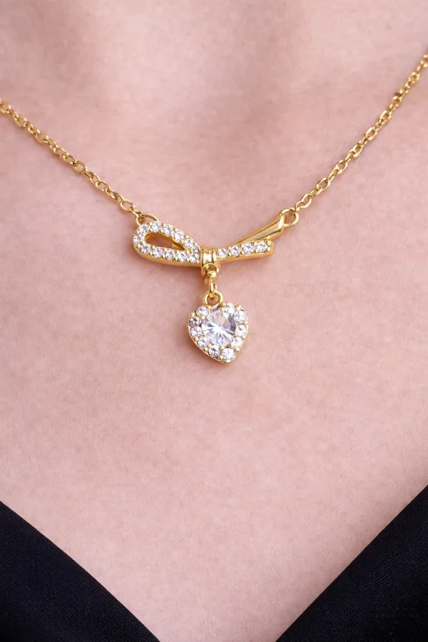 Gold_Ribbon_Bow_Necklace_With_Dainty_Heart_Drop