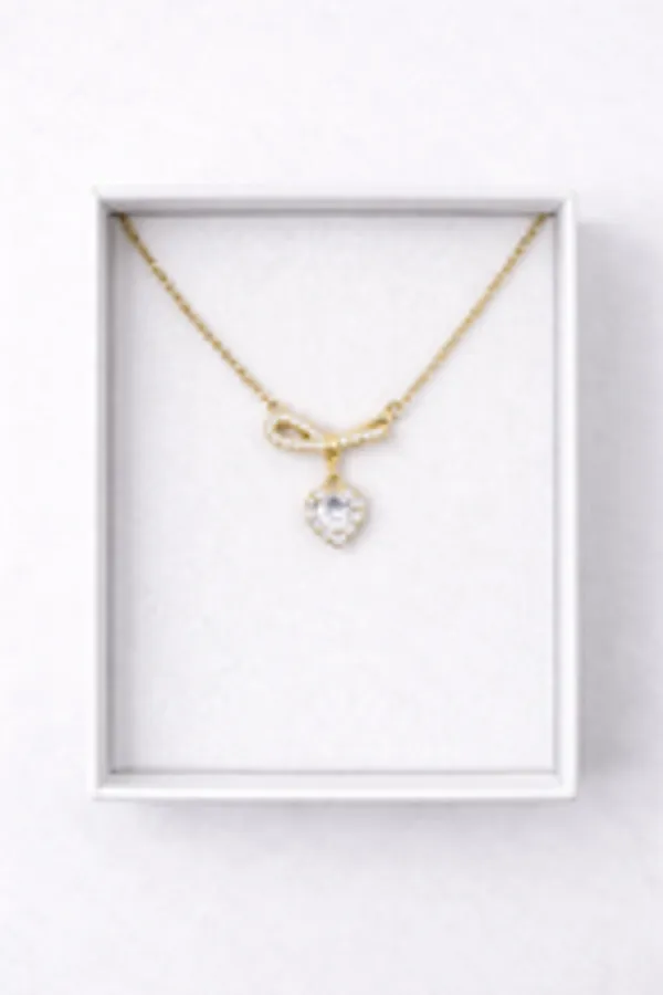 Gold_Ribbon_Bow_Necklace_With_Dainty_Heart_Drop