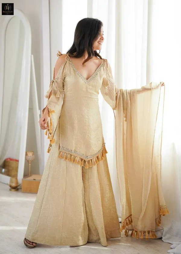 Luminous_Beige-Gold_Textured_Silk_Blend_Cold-Shoulder_Kurta_with_Sharara_&_Tasselled_Dupatta_Set