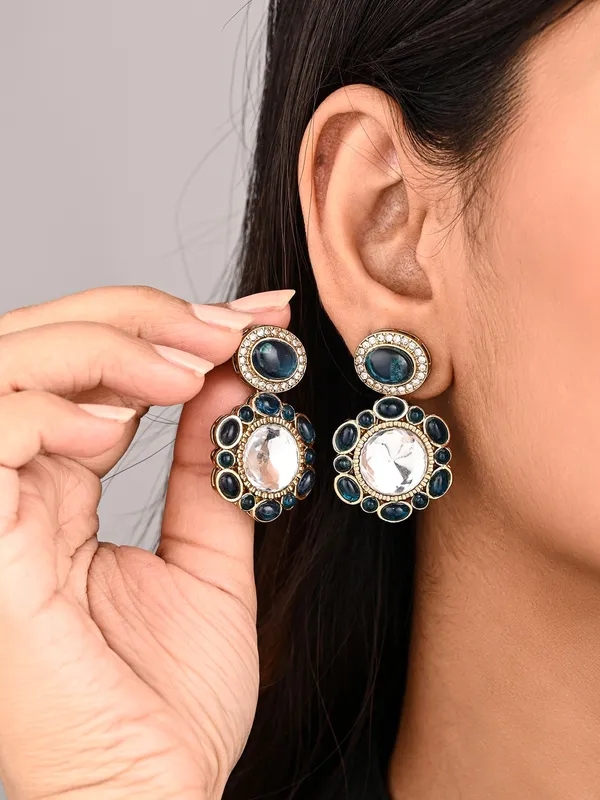 Statement_earrings_featuring_a_bold_circular_design_with_a_vintage_finish