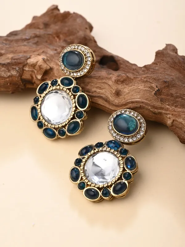 Statement_earrings_featuring_a_bold_circular_design_with_a_vintage_finish
