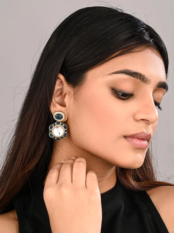 Statement_earrings_featuring_a_bold_circular_design_with_a_vintage_finish