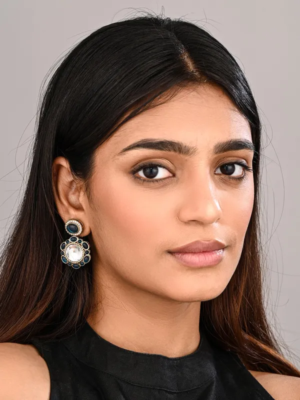 Statement_earrings_featuring_a_bold_circular_design_with_a_vintage_finish