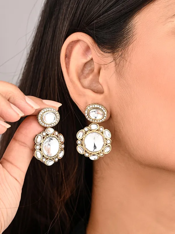 Statement_earrings_featuring_a_bold_circular_design_with_a_vintage_finish