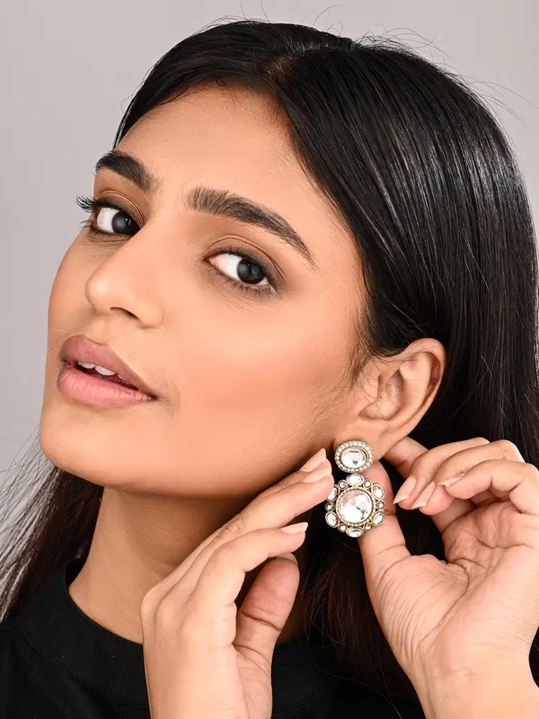 Statement_earrings_featuring_a_bold_circular_design_with_a_vintage_finish