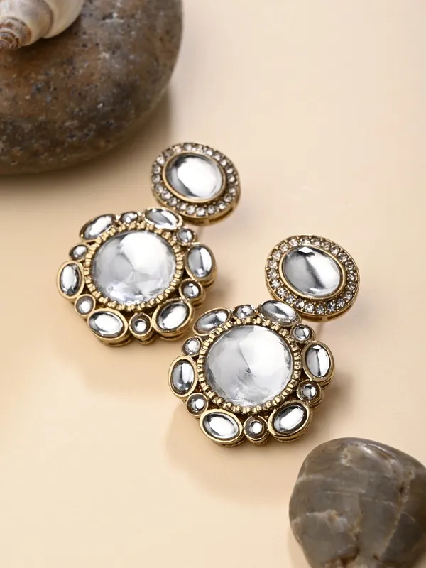 Statement_earrings_featuring_a_bold_circular_design_with_a_vintage_finish
