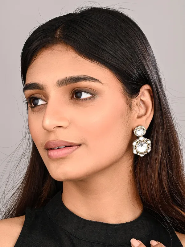 Statement_earrings_featuring_a_bold_circular_design_with_a_vintage_finish