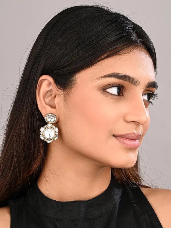 Statement_earrings_featuring_a_bold_circular_design_with_a_vintage_finish