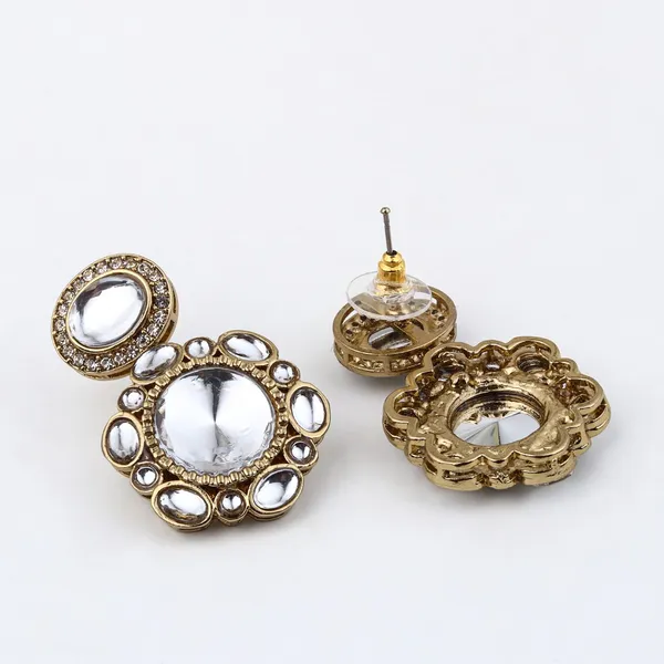 Statement_earrings_featuring_a_bold_circular_design_with_a_vintage_finish