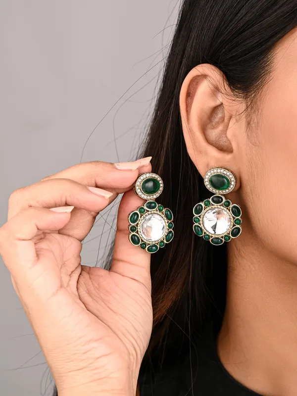 Statement_earrings_featuring_a_bold_circular_design_with_a_vintage_finish