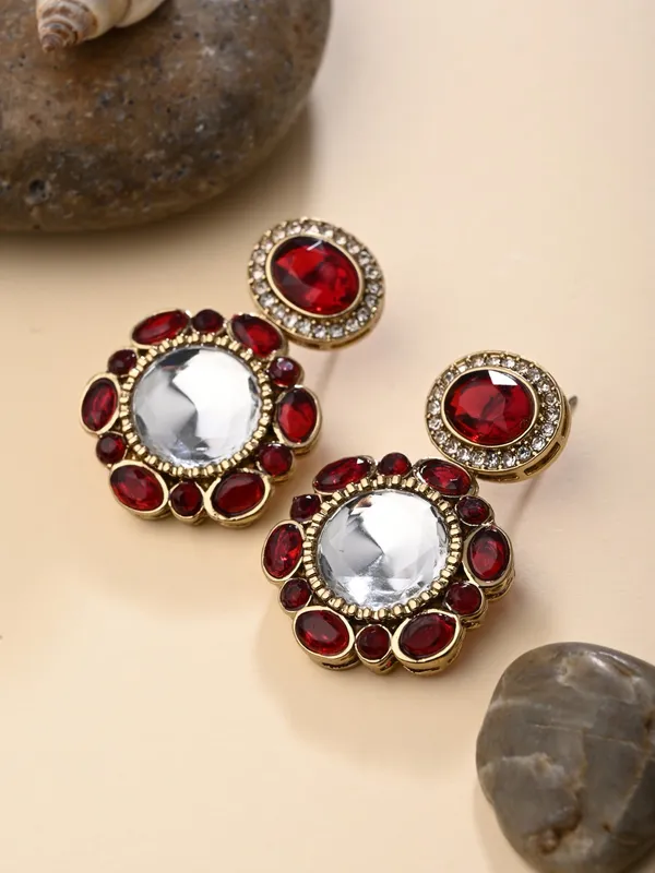 Statement_earrings_featuring_a_bold_circular_design_with_a_vintage_finish