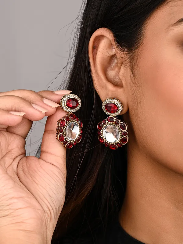 Statement_earrings_featuring_a_bold_circular_design_with_a_vintage_finish