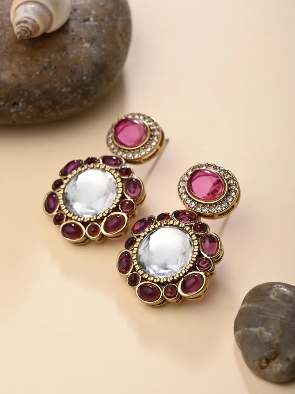 Statement_earrings_featuring_a_bold_circular_design_with_a_vintage_finish