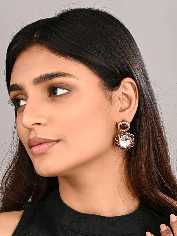 Statement_earrings_featuring_a_bold_circular_design_with_a_vintage_finish
