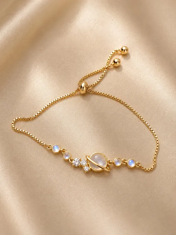 Elegant_Gold_Tone_Adjustable_Planet_Bracelet_For_Women_With_Saturn_Inspired_Centre_Design_Sparkling_Crystal_Accents_And_Blue_Moonstone_Style_Beads_Trendy_Fashion_Jewellery_For_Party_Casual_And_Everyday_Wear