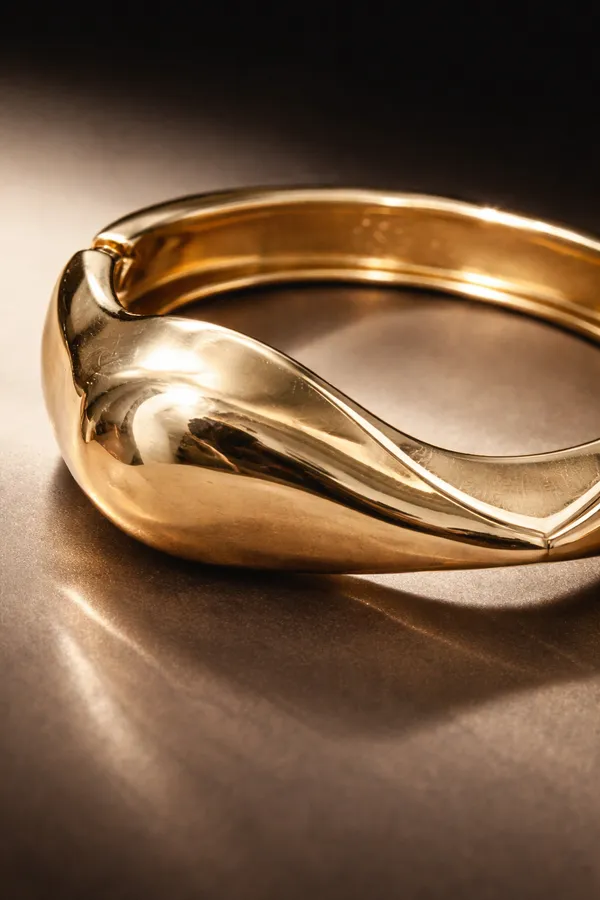 Gold_Stainless_Steel_Sculpted_Wave_Statement_Bangle_For_Women