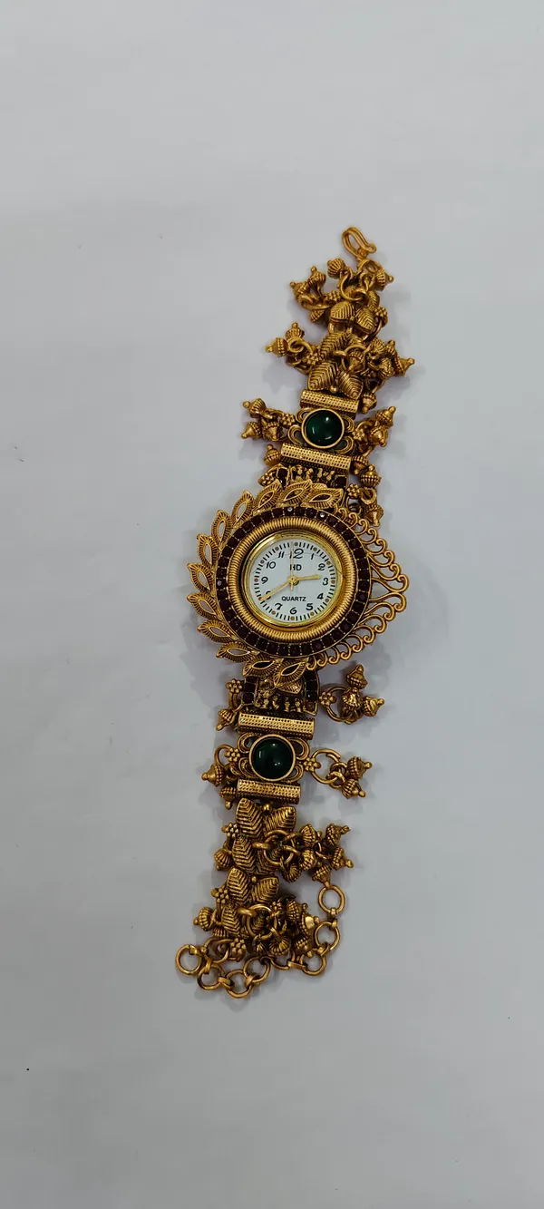 Gold_Tone_Ornate_Bracelet_Watch_With_Green_Stone_Details