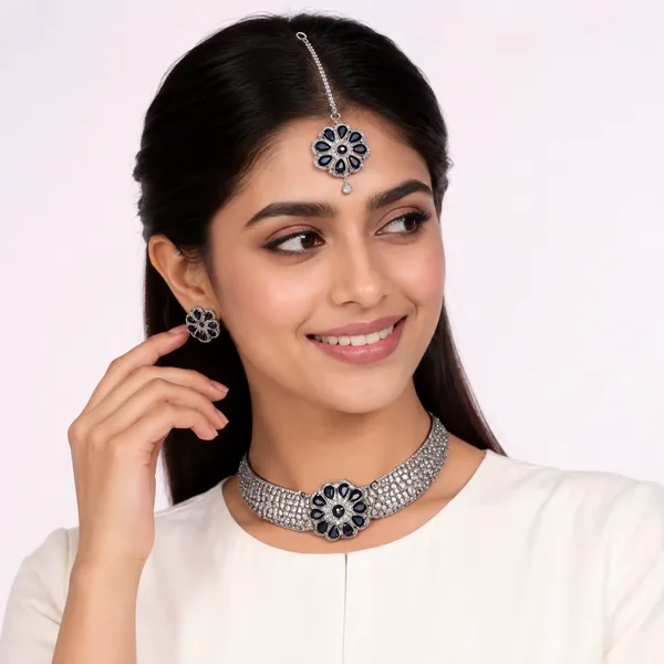 AD_Choker_Necklace_Set_with_Blue_Sapphire_Floral_Detail
Includes_Earrings_&_Tika,_Brooch-Style_Centre,_Silver_Tone_Finish,_Cubic_Zirconia