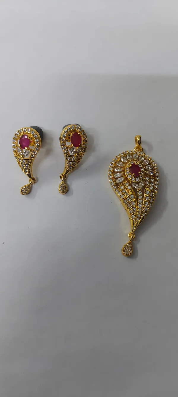 Gold_Tone_AD_Teardrop_Pendant_Set_with_Earrings
Ruby_Stone_Centre,_CZ_Stone_Studded,_Paisley_Design,_Stud_Earrings,_Festive_Jewellery